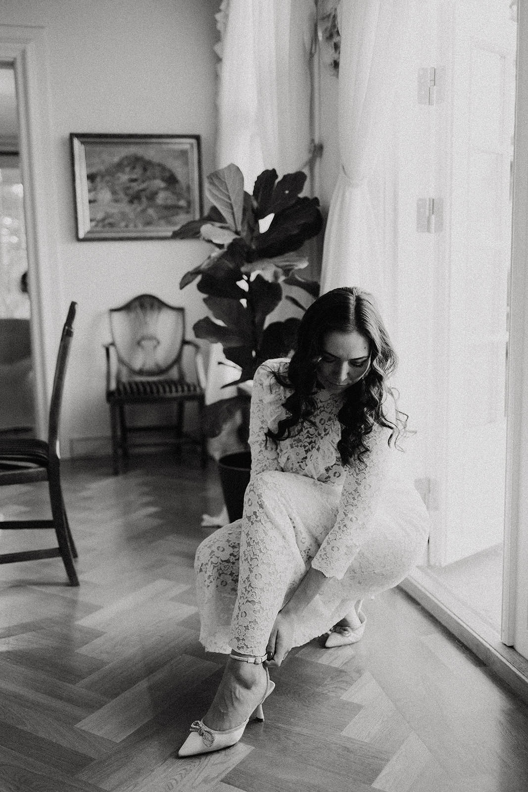 Elegant bride preparing for wedding photoshoot, indoor setting with natural light.