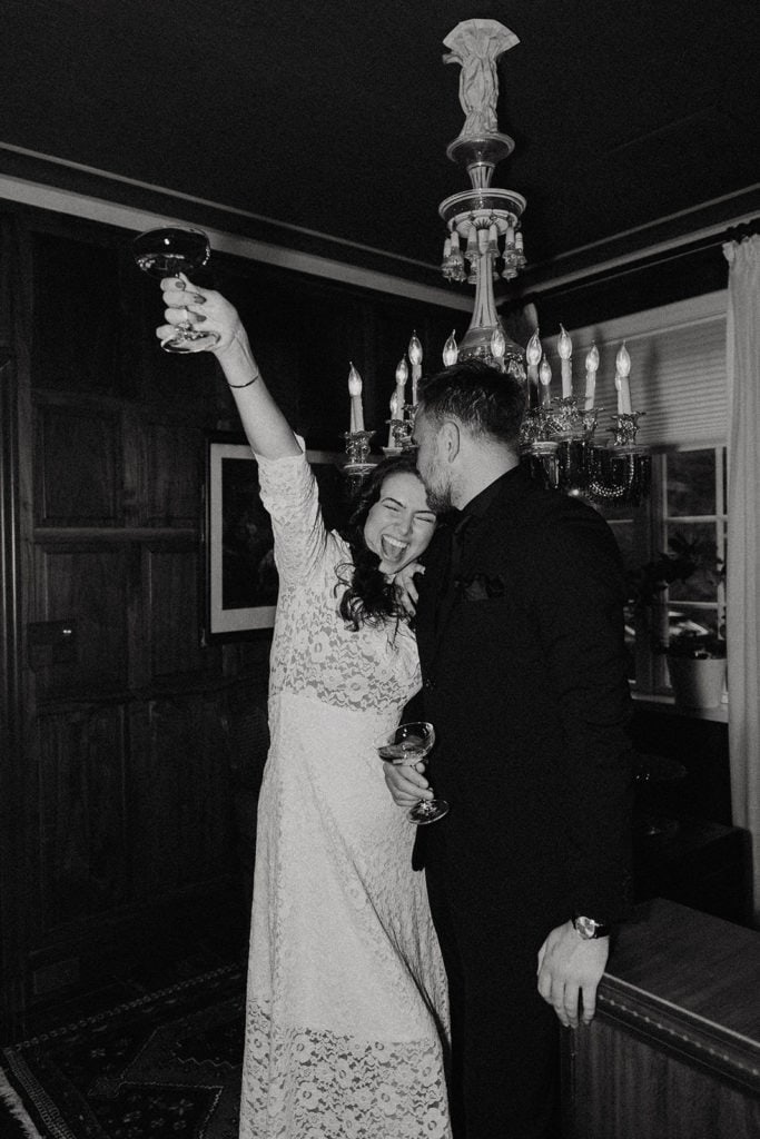 Elegant bride and groom celebrating at wedding reception, capturing joyful moments.