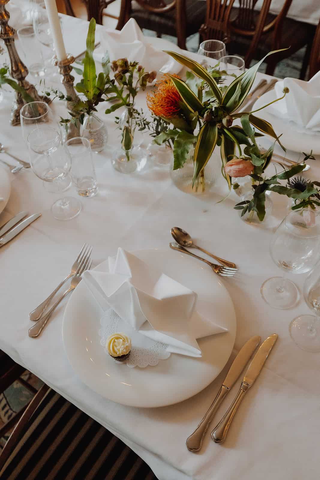 Elegant wedding table setting with floral centerpiece for bridal photography workshop.